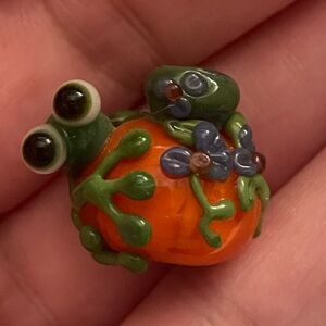 Glass bead frog on pumpkin